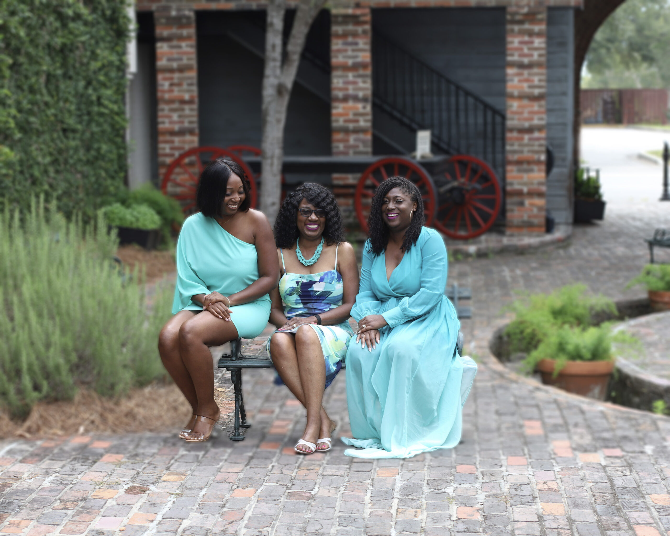 Mom and Daughters Portrait sitting on bench and laughing